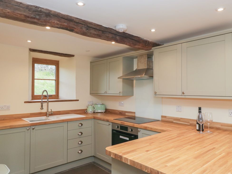A kitchen with sink and cabinets at Howgill Head in Kendal