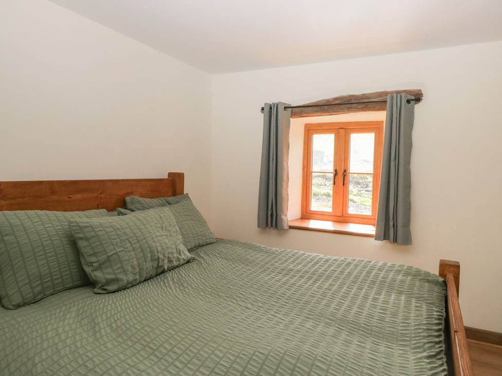A bedroom with a bed and a window at Howgill Head in Kendal