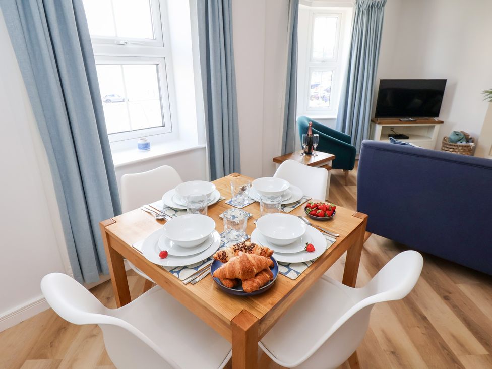 A dining table set with plates and food at Belle's View in Scarborough