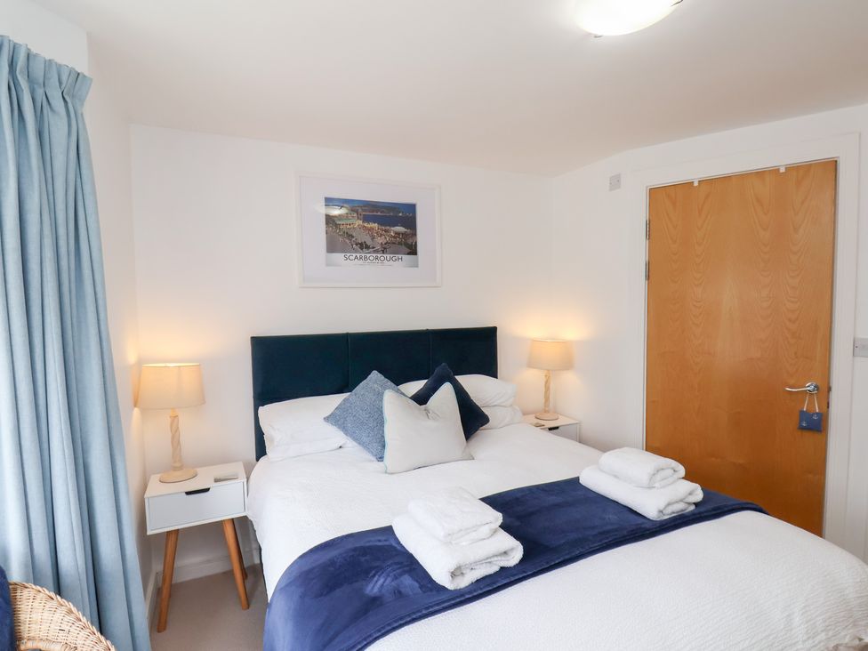 A bedroom with a double bed and nightstand at Belle's View in Scarborough