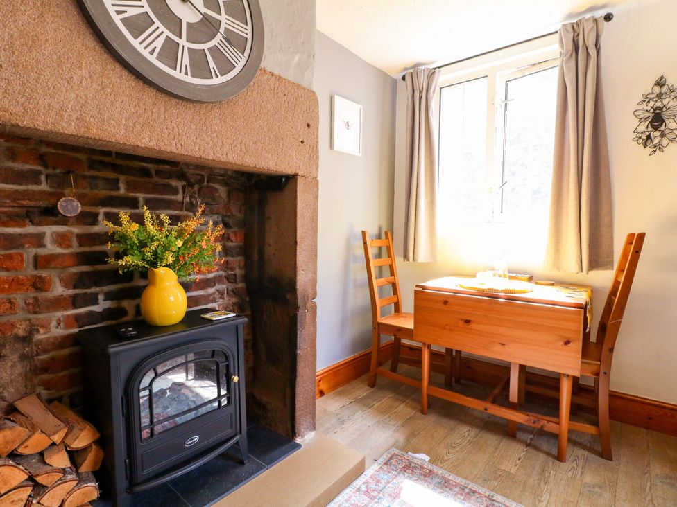 A dining room with a table and chairs at The Beehive in Wirksworth