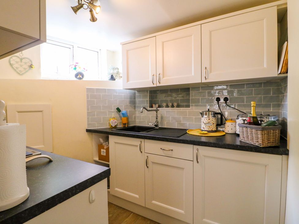 A kitchen with cabinets, sink and countertop at The Beehive in Wirksworth