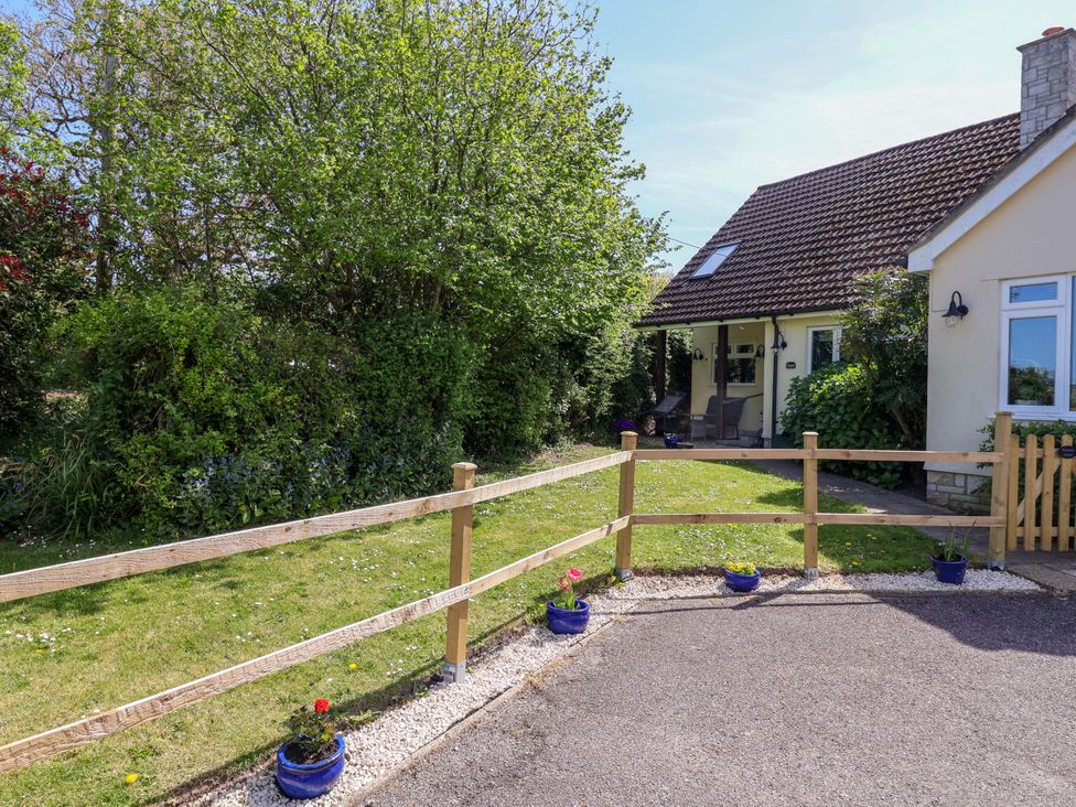 A house with a garden and fence at Rosemarie Annexe in Axminster