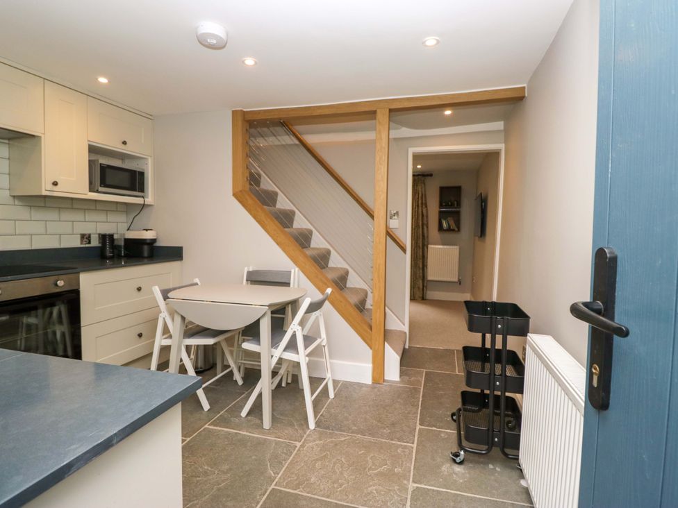 A kitchen with chairs and a table at Dove Cottage Ambleside