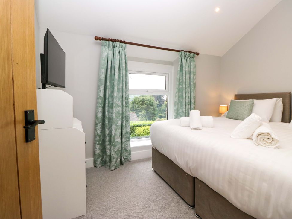 A bedroom with a bed and television at Dove Cottage in Ambleside