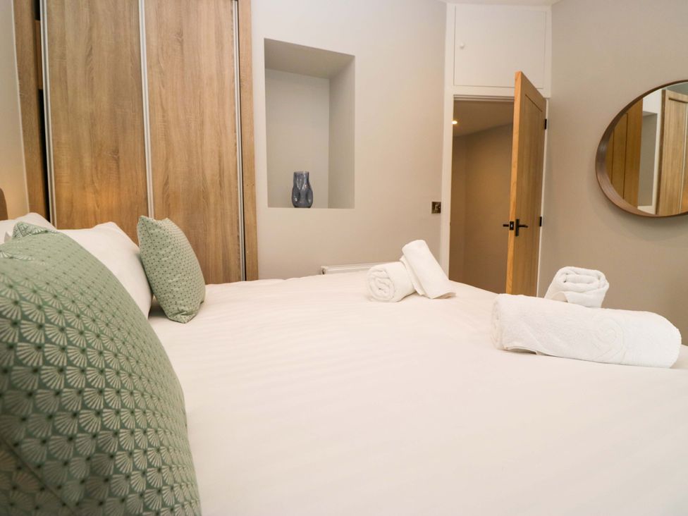 A bedroom with a bed and decorative pillows at Dove Cottage in Ambleside