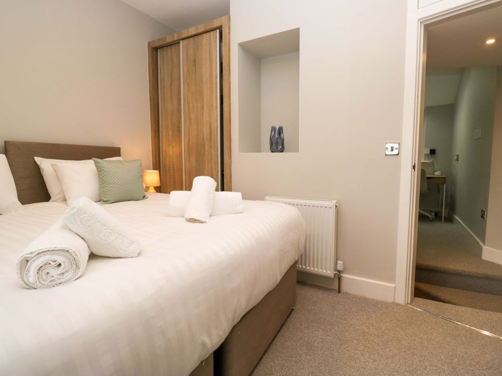 A bedroom with a double bed and a wardrobe at Dove Cottage in Ambleside