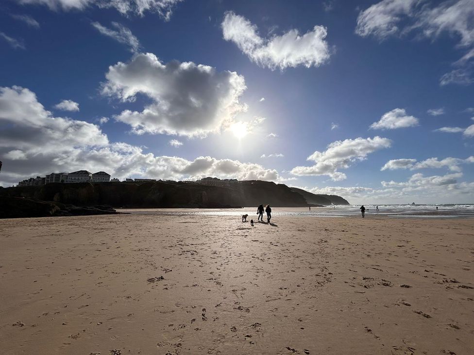 A beach scene with people walking near the water at Buzzards Lodge near Victoria