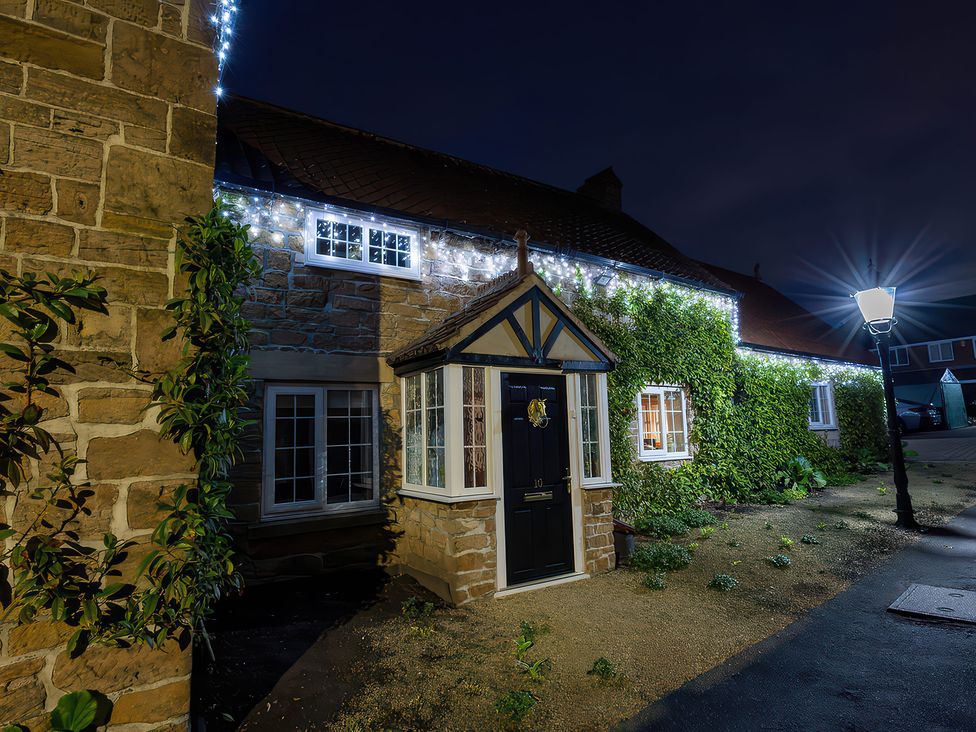 A house with lights and a pathway at Rose Cottage in Kirkby-In-Ashfield