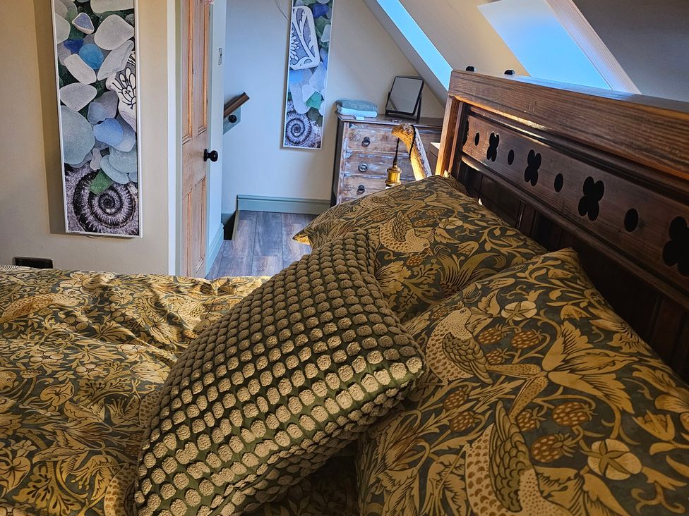 A bedroom with a bed and decorative pillows at Driftwood in Bridlington