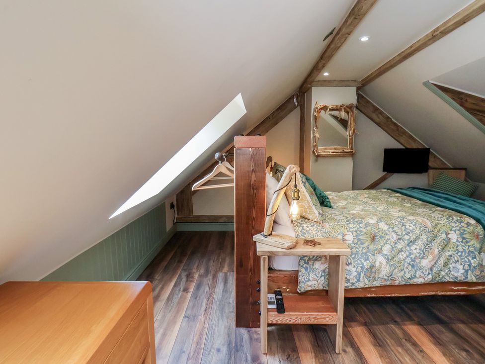 A bedroom with a bed and a bedside table at Driftwood in Flamborough