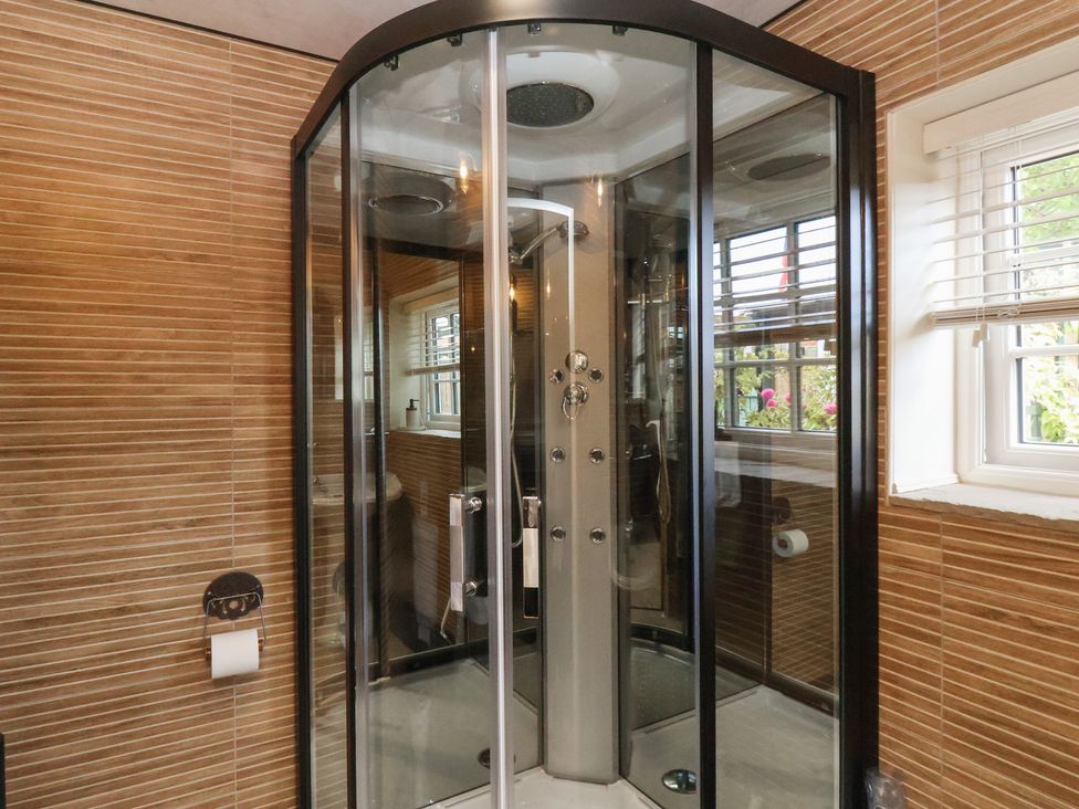 A shower enclosure in a bathroom at Driftwood in Flamborough