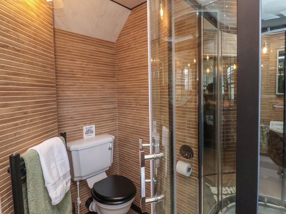 A bathroom featuring a shower and toilet at Driftwood in Flamborough