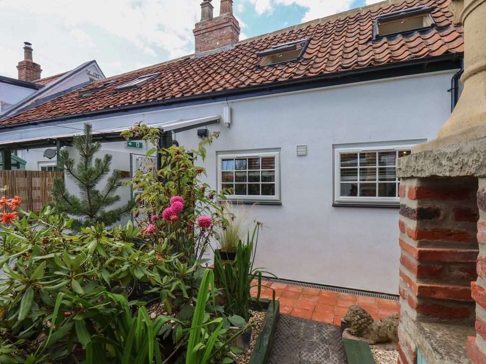 An outdoor view of a house with plants and a pathway at Driftwood in Flamborough