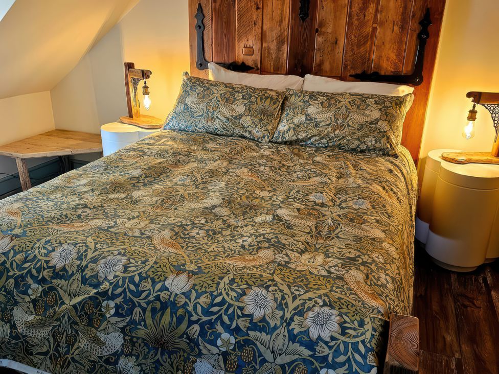 A bedroom with a bed and nightstands at Seaglass in Bridlington