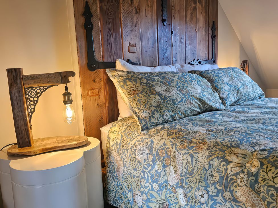 A bedroom with a bed and wooden wall at Seaglass in Bridlington
