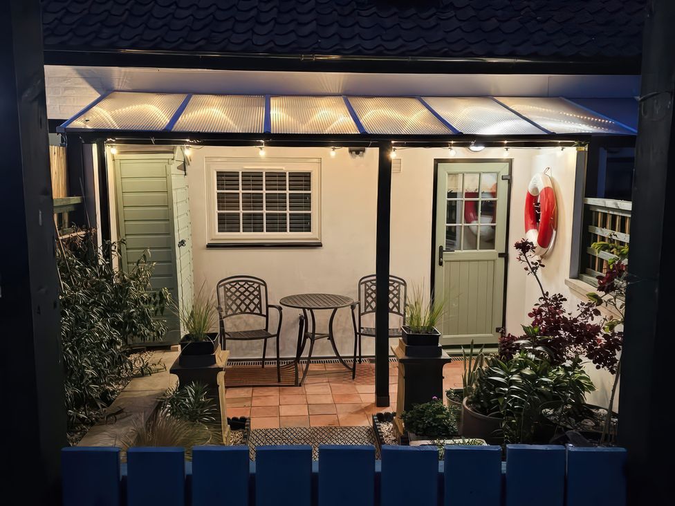 An outdoor seating area with a table and chairs at Seaglass in Bridlington
