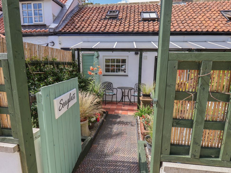 An outdoor area with a table and chairs at Seaglass in Flamborough