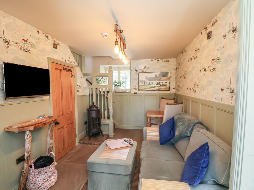 A snug room with a sofa and television at Seaglass in Flamborough