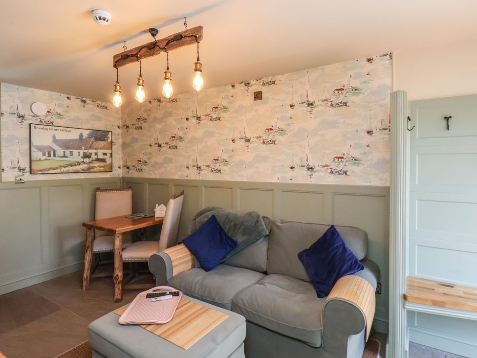 A snug with a sofa and dining table at Seaglass in Flamborough