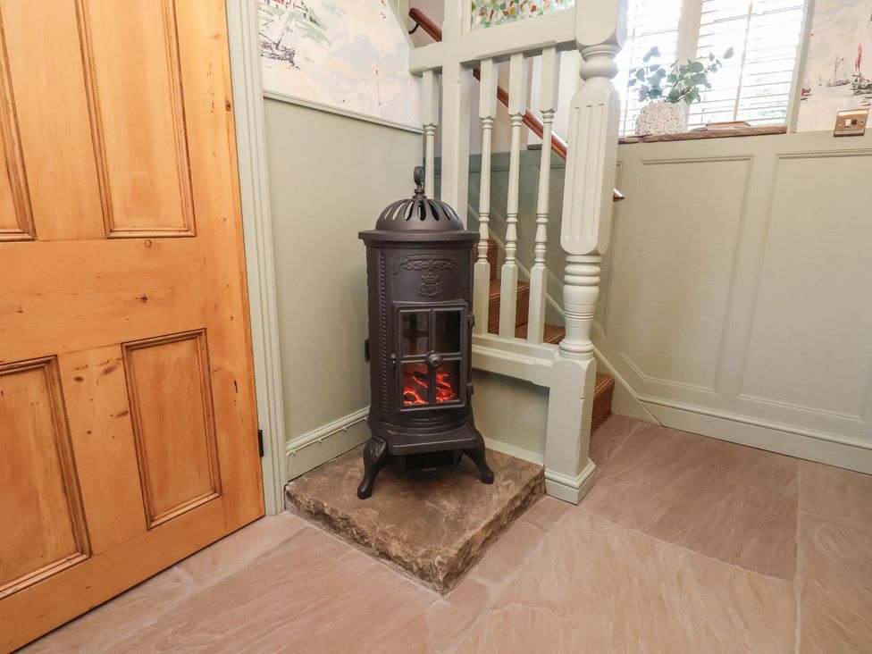 A hallway with a stove and a door at Seaglass in Flamborough