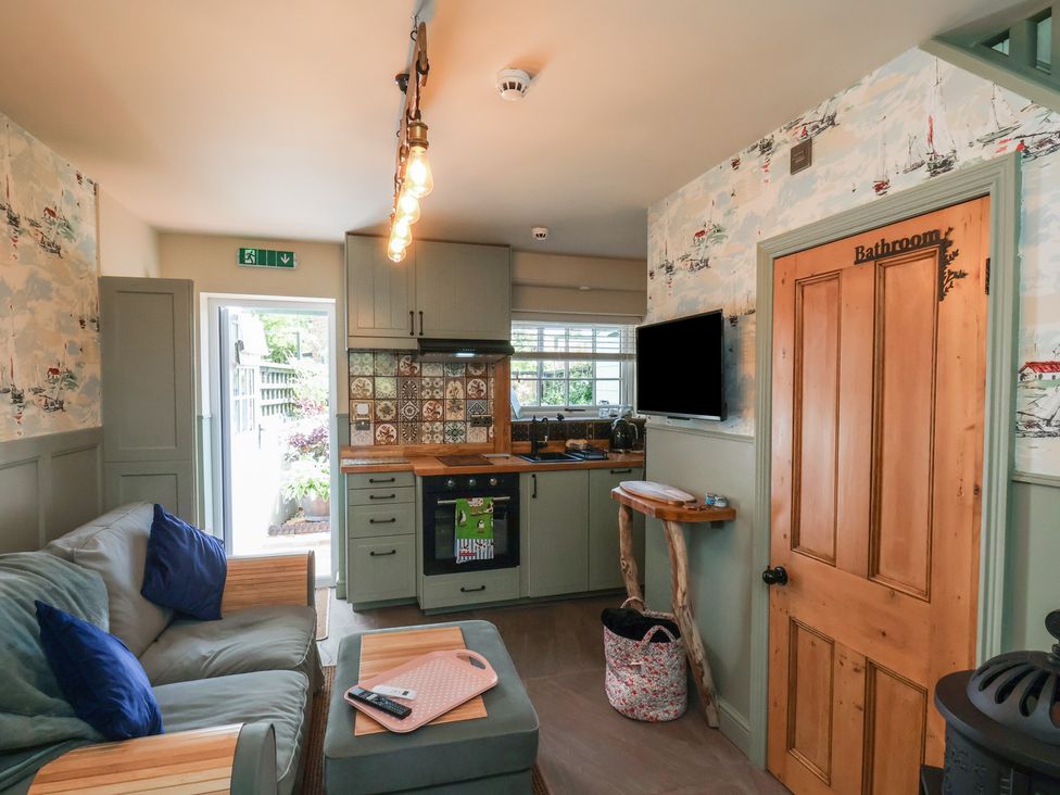 A kitchen with a sofa and cooking area at Seaglass in Flamborough