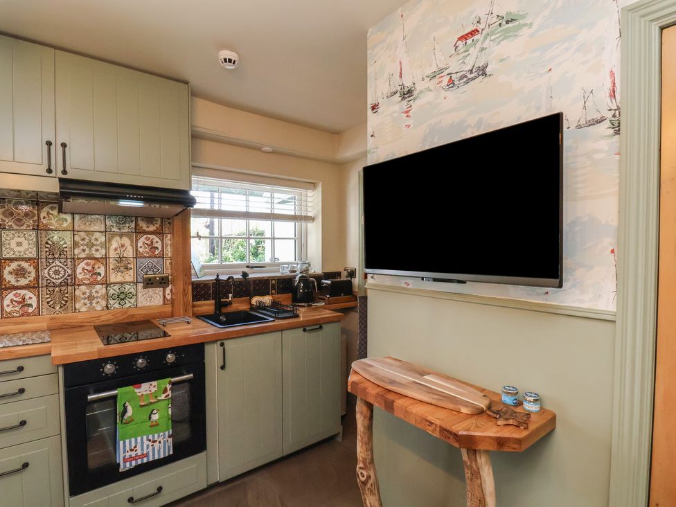 A kitchen with cabinets, oven, and sink at Seaglass in Flamborough