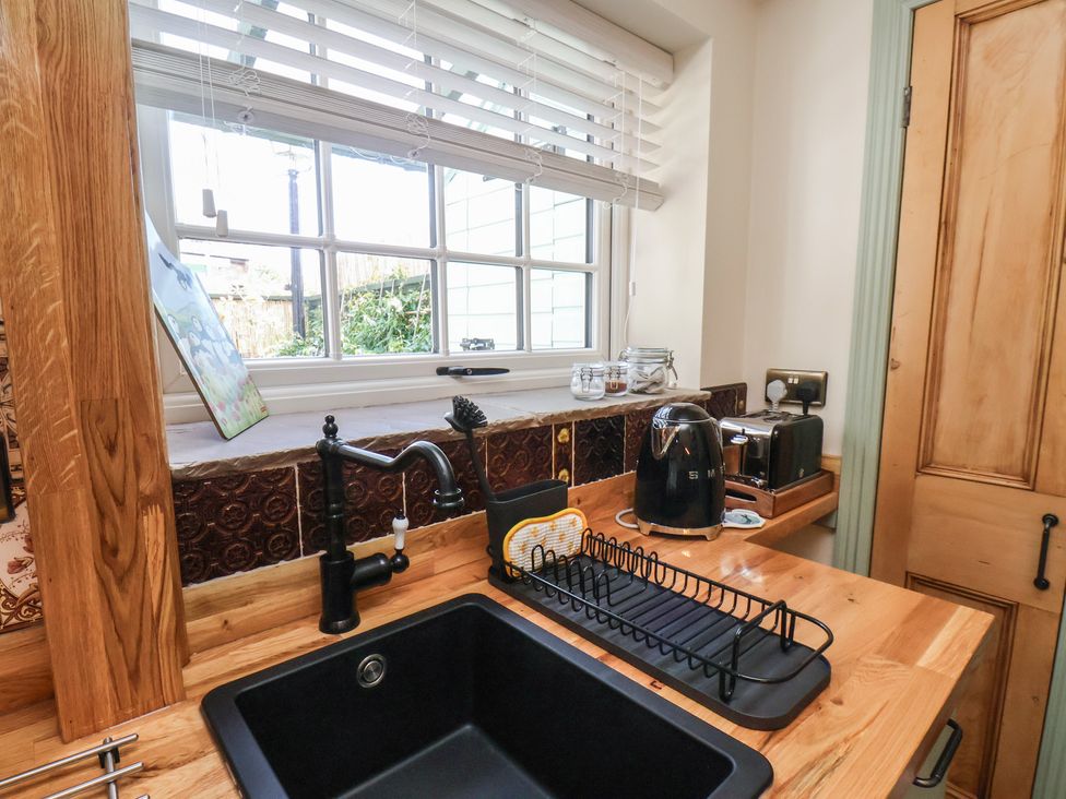 A kitchen with a sink and kettle at Seaglass in Flamborough
