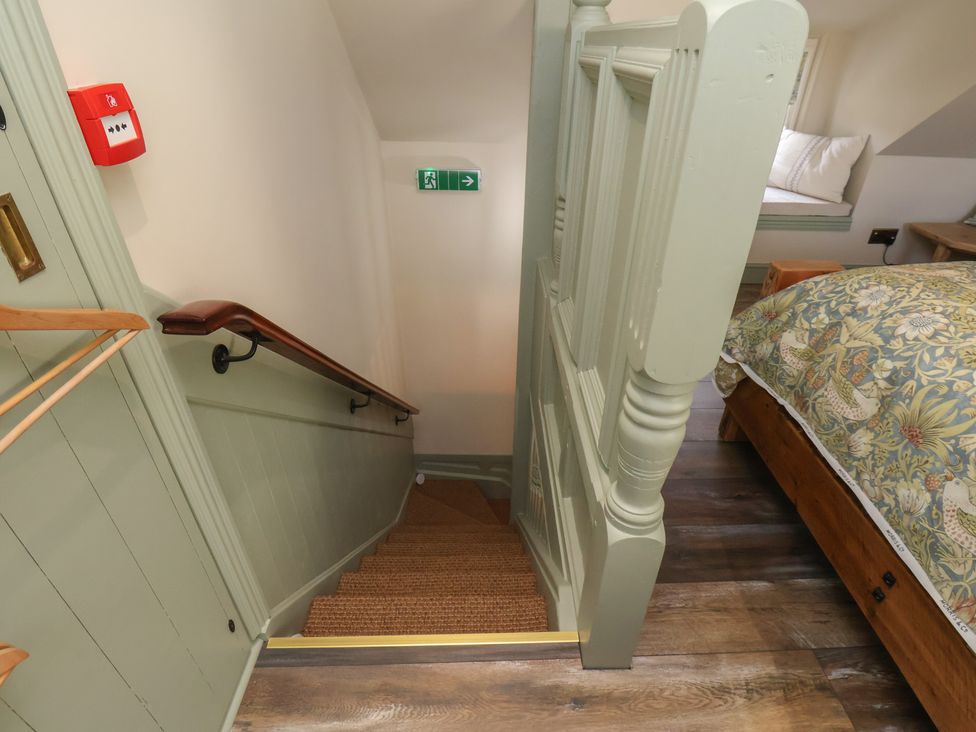 A staircase leading down with a handrail at Seaglass in Flamborough