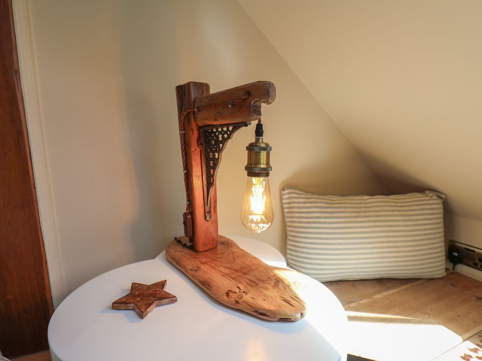 A table lamp with a wooden base and a bulb at Seaglass in Flamborough