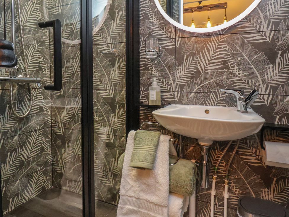 A bathroom with shower and sink at Seaglass in Flamborough