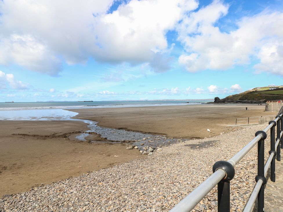 A beach view with water and clouds at Puffin Nook in Broad Haven