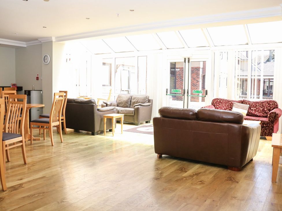 A living room with tables and sofas at Pebble Path in Littlehampton