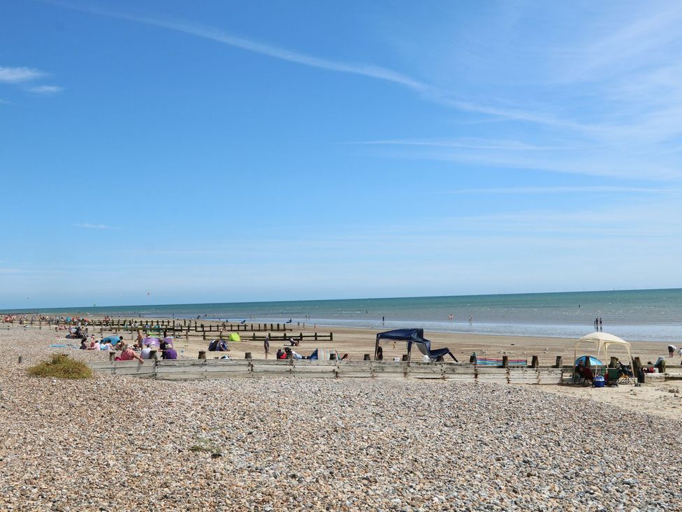 A beach with people and tents at Pebble Path in Littlehampton