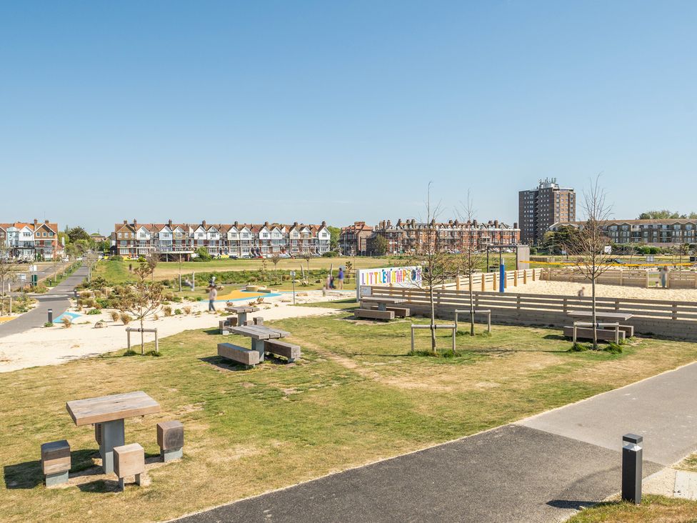 An outdoor area with benches and tables at Marine Court Suite Littlehampton