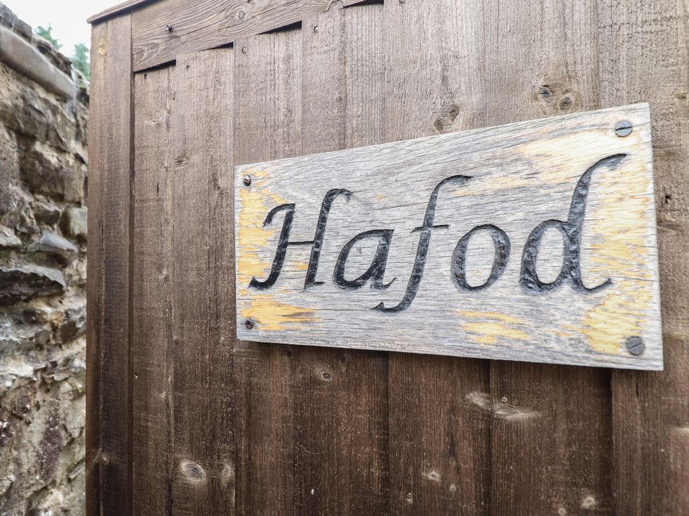 A wooden sign with the name Hafod on a fence at Hafod in Llangollen