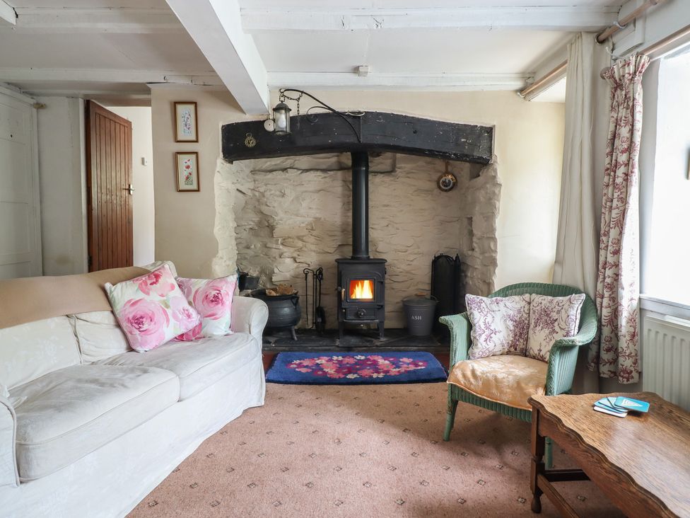 A living room with a fireplace and sofa at Hafod in Llangollen