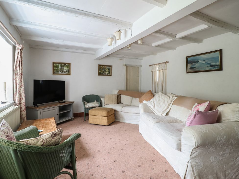 A living room with a television and sofa at Hafod in Llangollen