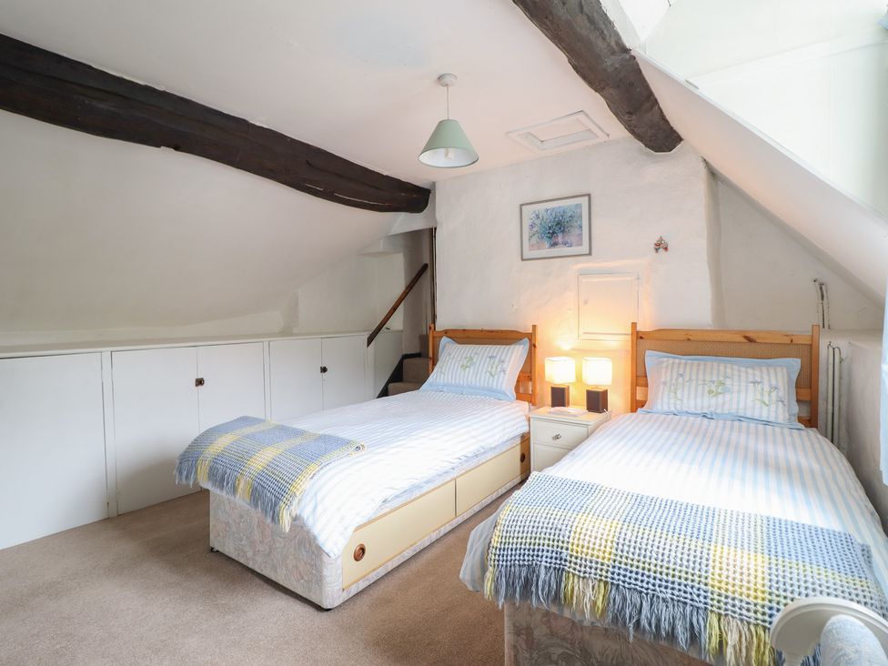 A bedroom with two beds and a lamp at Hafod in Llangollen