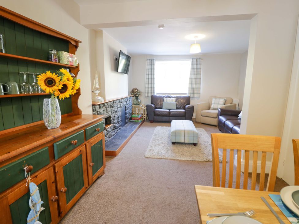 A living room with a shelf and sofa at Bryn Hyfryd in Conwy