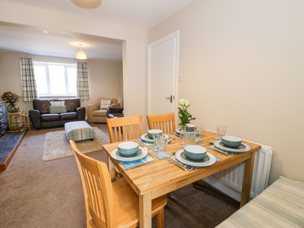 A dining area with a table set for meals at Bryn Hyfryd in Conwy