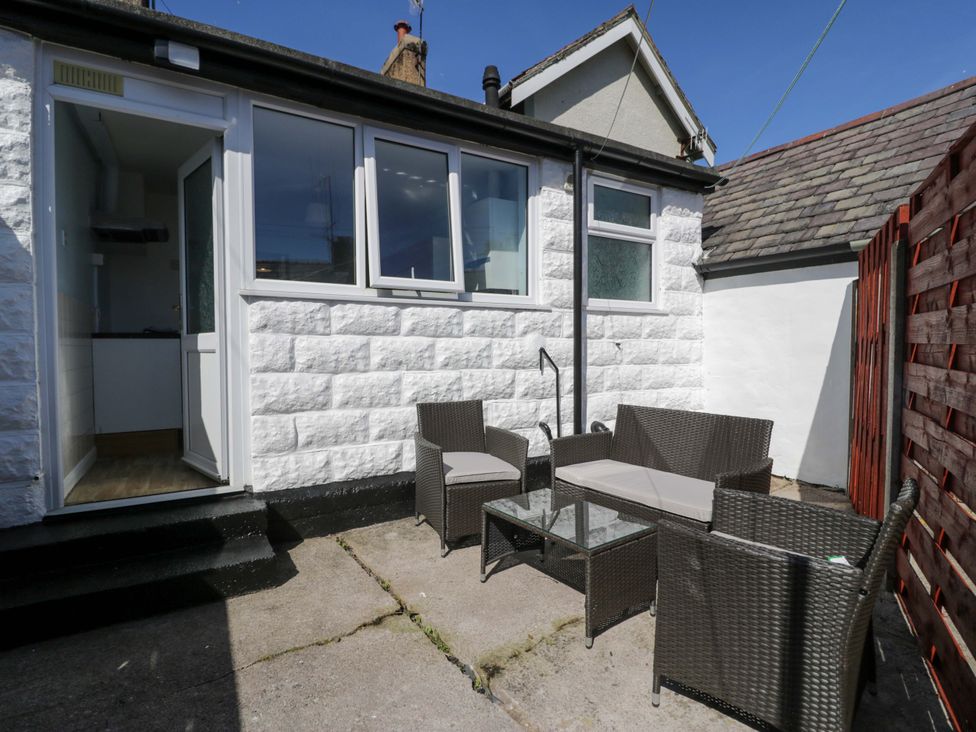 An outdoor area with seating and a door at Bryn Hyfryd in Conwy