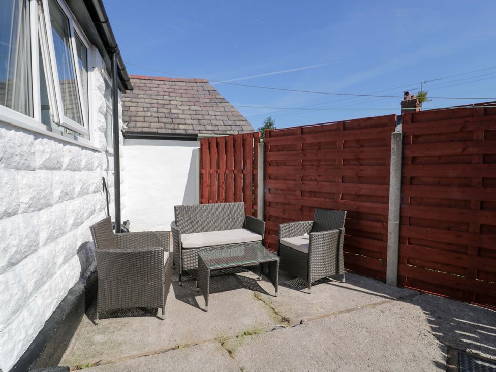 An outdoor seating area with table and chairs at Bryn Hyfryd in Conwy