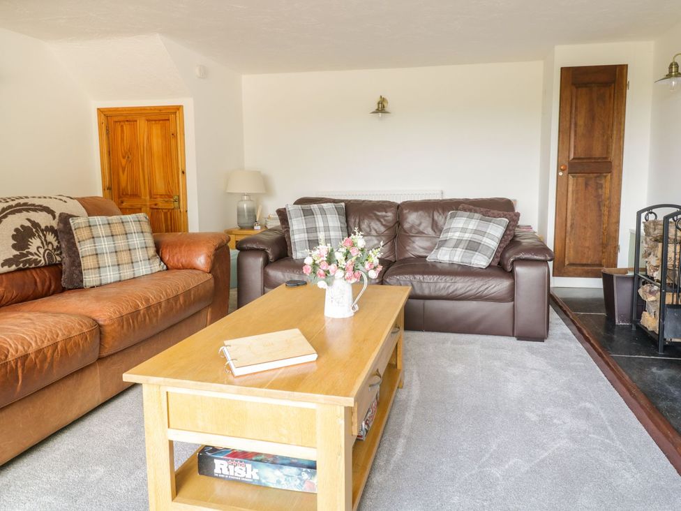 A living room with a sofa and coffee table at Cyffdy Cottage - Aran in Bala