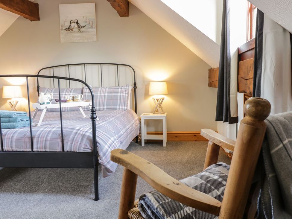 A bedroom with a bed and bedside table at Cyffdy Cottage - Aran Bala