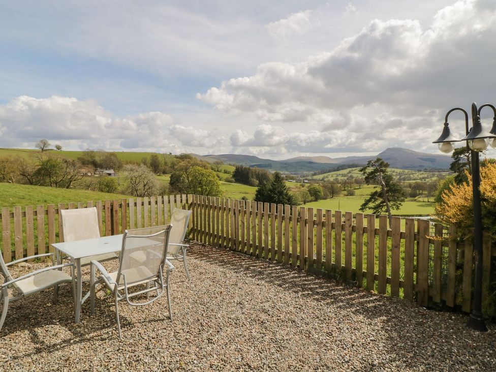 A patio with table and chairs at Cyffdy Cottage - Aran in Bala