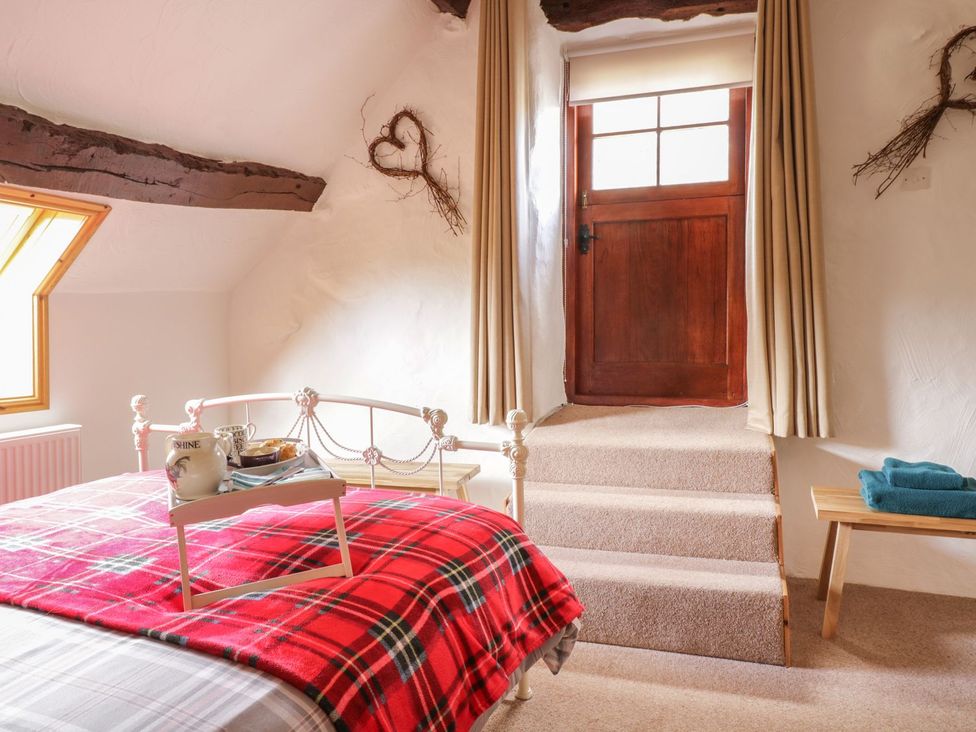 A bedroom with a bed and window at Cyffdy Cottage - Tegid in Bala