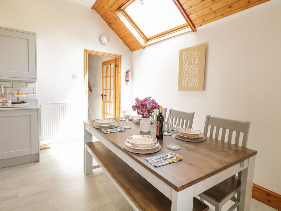 A dining room with a table set for a meal at Cyffdy Cottage - Tegid Bala