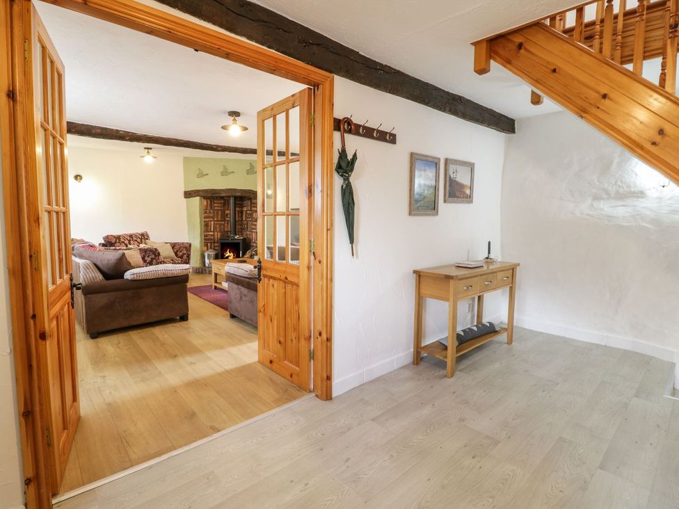 A living room with a sofa and table at Cyffdy Cottage - Tegid, Bala