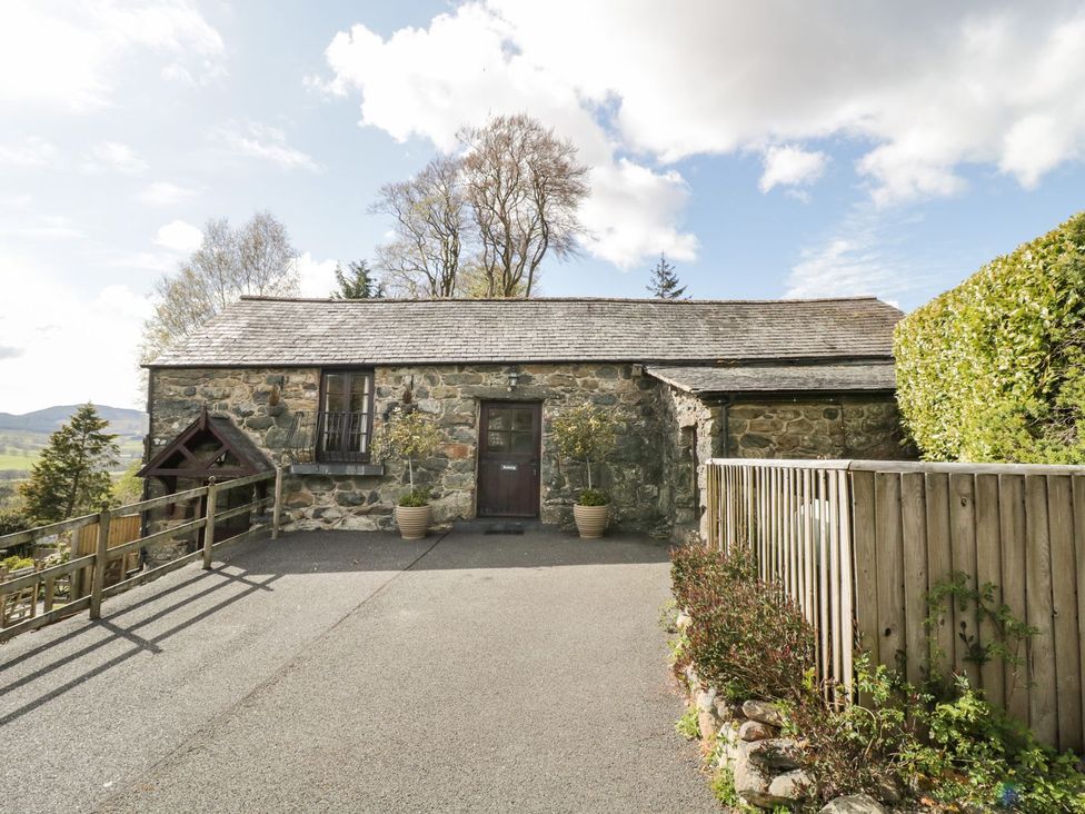 A stone building with a door and windows at Cyffdy Cottage - Arenig in Bala
